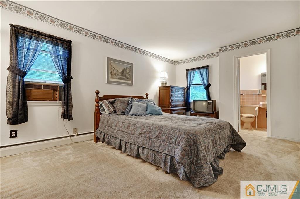 3 Delwood Road Chester, NJ 07930 - Photo 15 of 25 a bedroom with a large bed and a flat tv screen on dresser