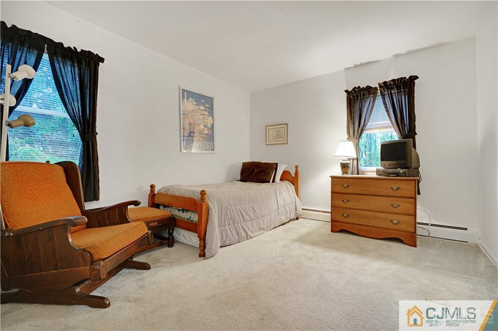3 Delwood Road Chester, NJ 07930 - Photo 18 of 25 a bedroom with furniture and a large window