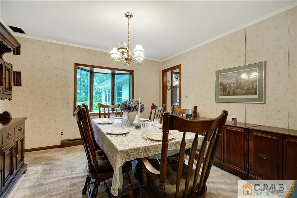 3 Delwood Road Chester, NJ 07930 - Photo 4 of 25 a view of a dining room with furniture a chandelier and wooden floor