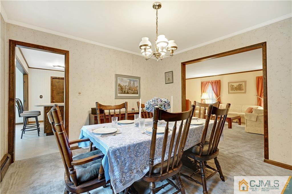 3 Delwood Road Chester, NJ 07930 - Photo 5 of 25 a view of a dining room with furniture a chandelier and wooden floor