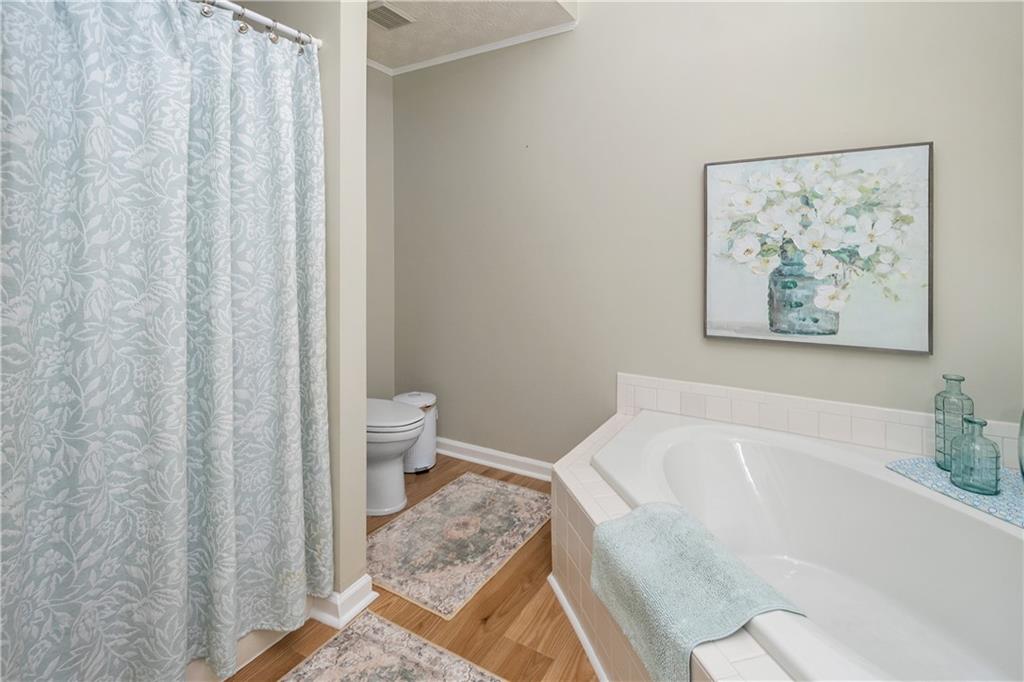 405 Ridgemont Drive Fayetteville, GA 30215 - Photo 22 of 43 a bath room with a toilet and a bath tub