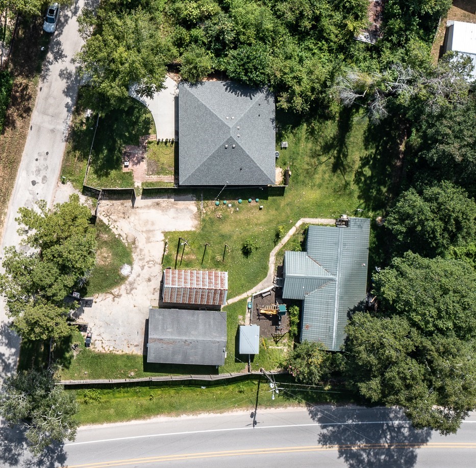 Aerial view from top to bottom: main property, with 3 BR, storage shed, event facility with back apartment, and to the right of the picture, the 3 BR mobile home, currently leased.