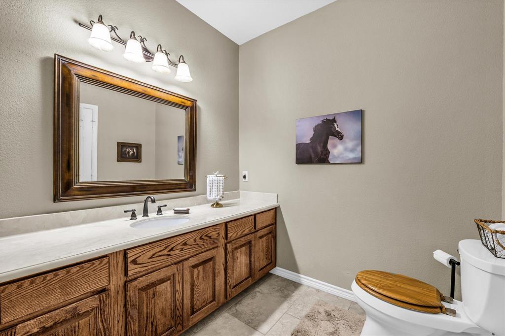 613 Bone Road Valley Mills, TX 76689 - Photo 21 of 40 a bathroom with a toilet a sink and mirror