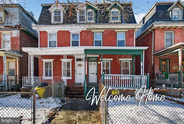 front view of a brick house with a large windows