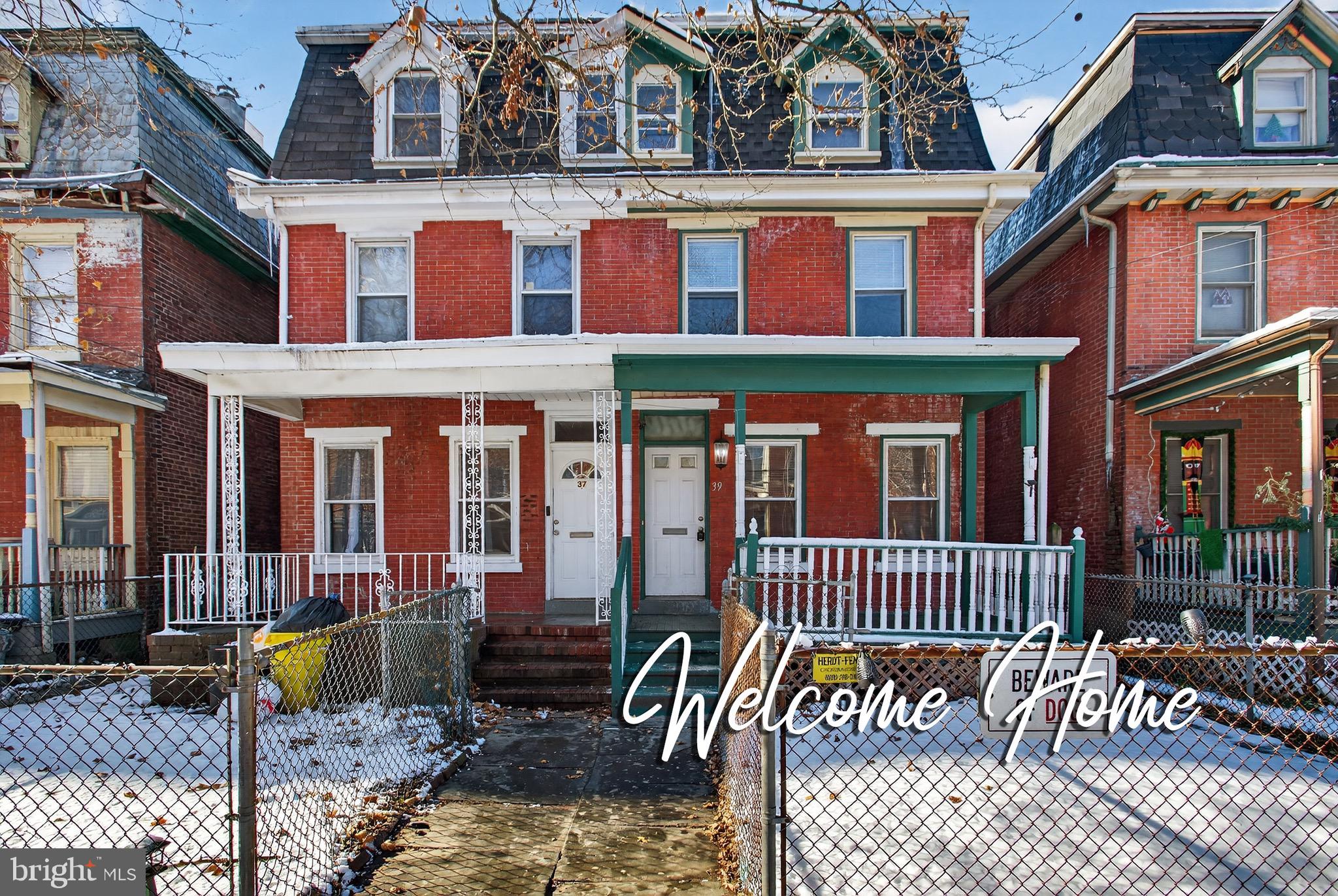 front view of a brick house with a large windows