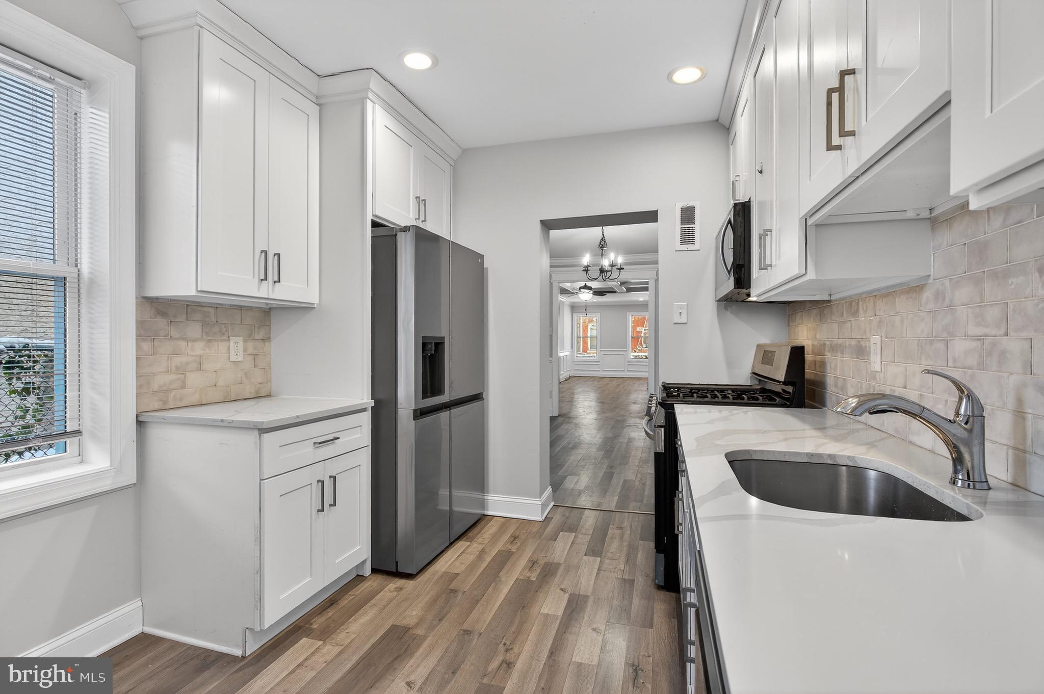 39 Carroll Street Trenton, NJ 08608 - Photo 15 of 27 a kitchen with stainless steel appliances granite countertop a refrigerator sink and wooden cabinets