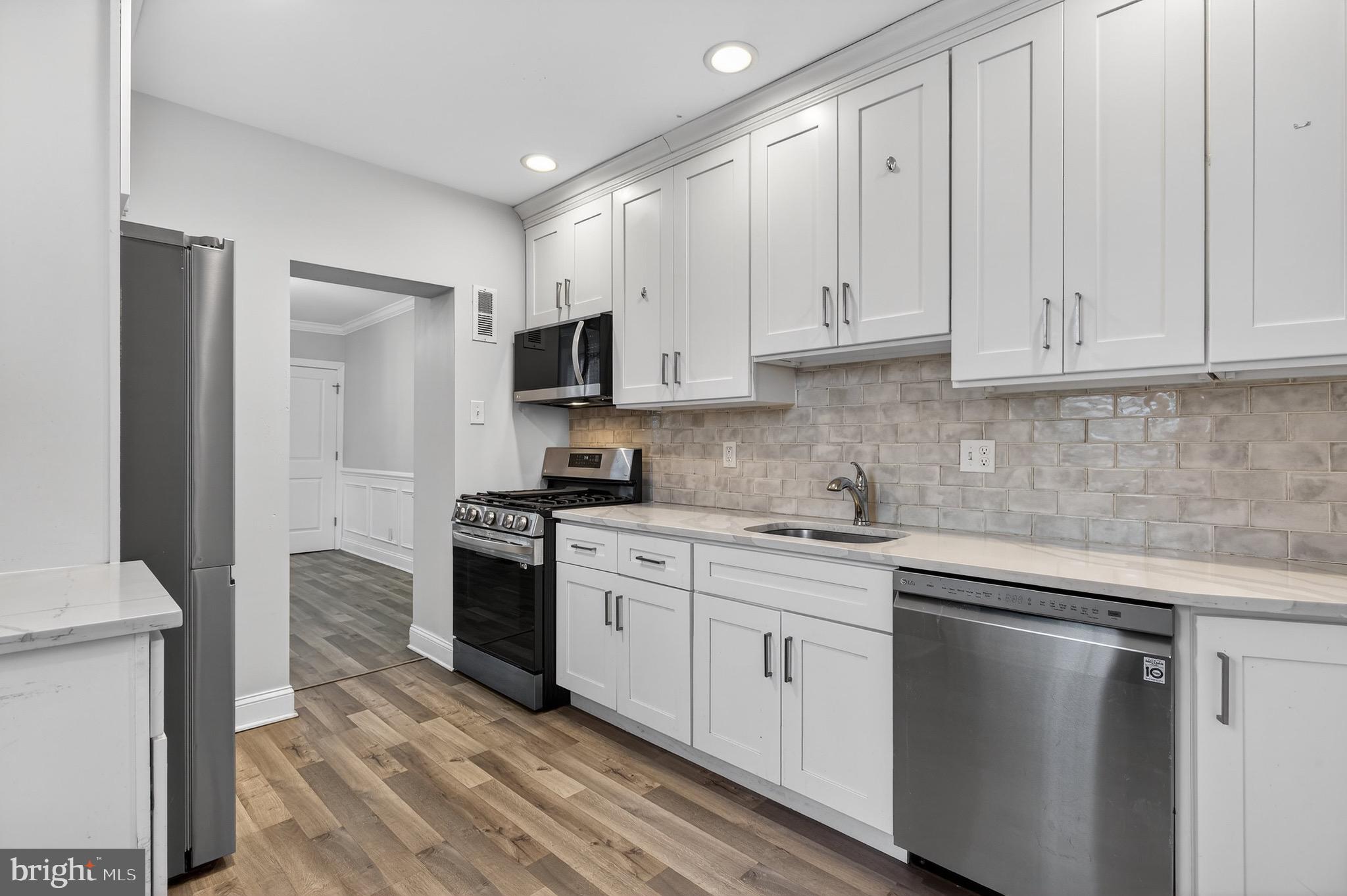 39 Carroll Street Trenton, NJ 08608 - Photo 16 of 27 a kitchen with cabinets appliances a sink and a counter top space