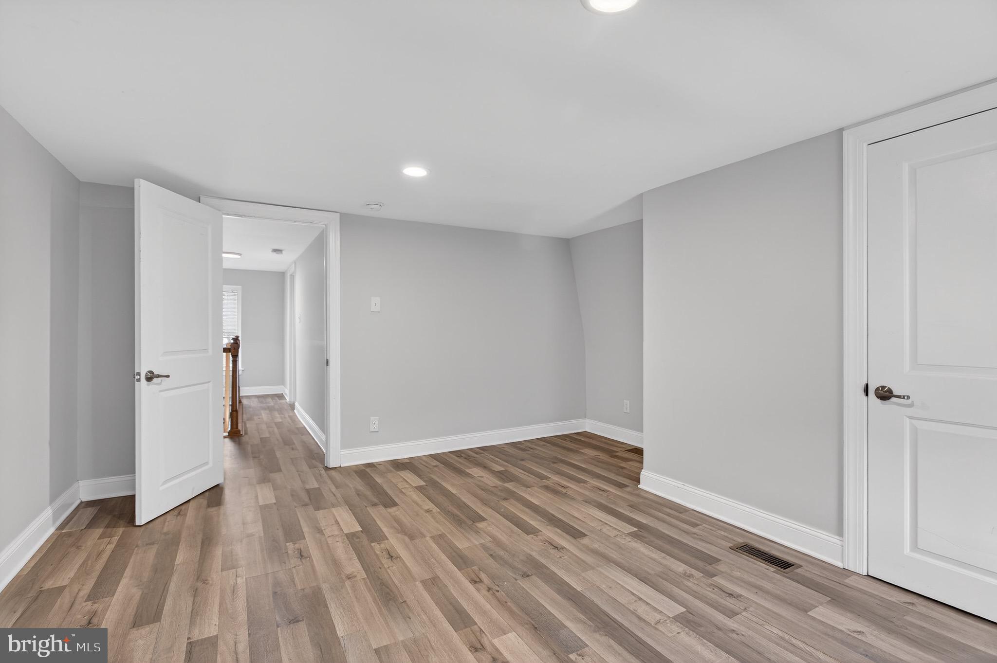 39 Carroll Street Trenton, NJ 08608 - Photo 17 of 27 wooden floor in an empty room with a window