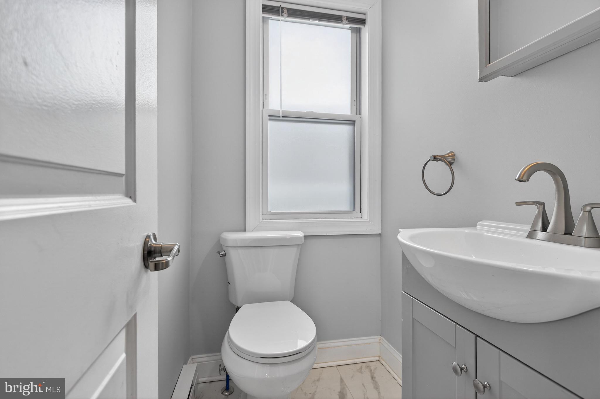 39 Carroll Street Trenton, NJ 08608 - Photo 22 of 27 a bathroom with a toilet sink and mirror