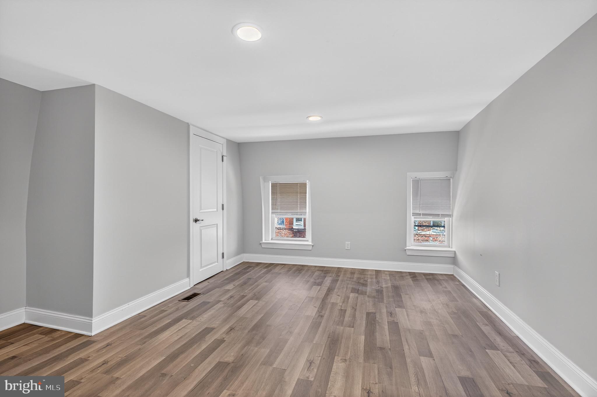 39 Carroll Street Trenton, NJ 08608 - Photo 24 of 27 an empty room with wooden floor and windows