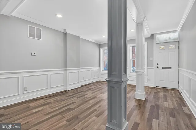 a view of empty room with wooden floor