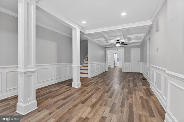 a view of empty room with wooden floor