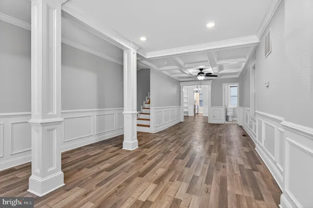 a view of an empty room and window with wooden floor