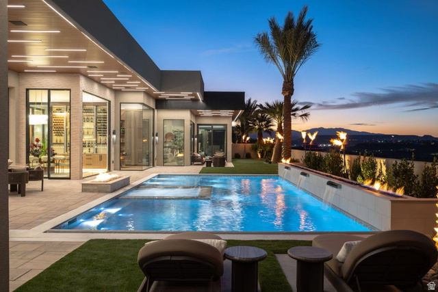 2867 East Granite Way St. George, UT 84790 - Photo 61 of 69 Contemporary outdoor pool with integrated spa, adjacent fire pit, and multiple water features