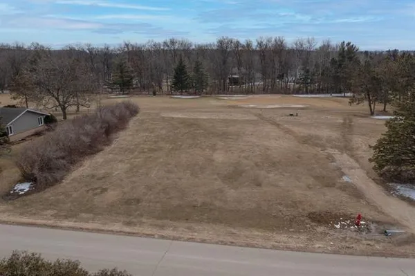 a view of dirt field with trees