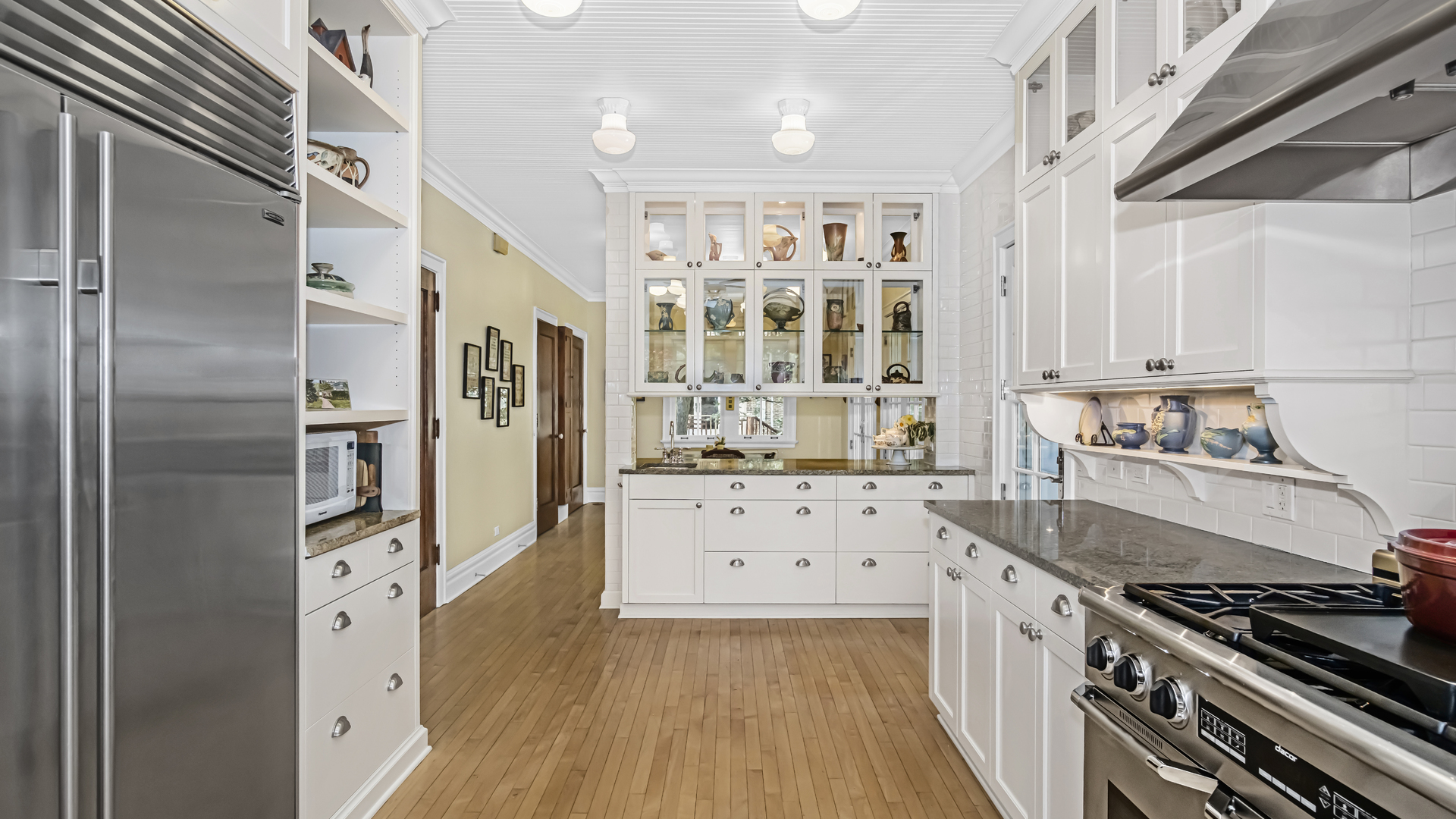 719 Milburn Street Evanston, IL 60201 - Photo 13 of 35 a kitchen with stainless steel appliances a stove a refrigerator and cabinets