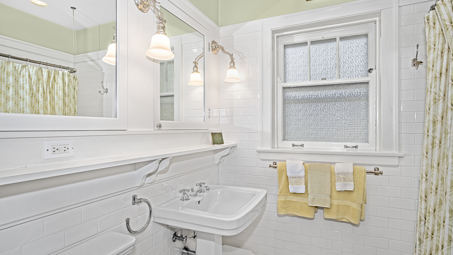 719 Milburn Street Evanston, IL 60201 - Photo 22 of 35 a bathroom with a sink and a mirror