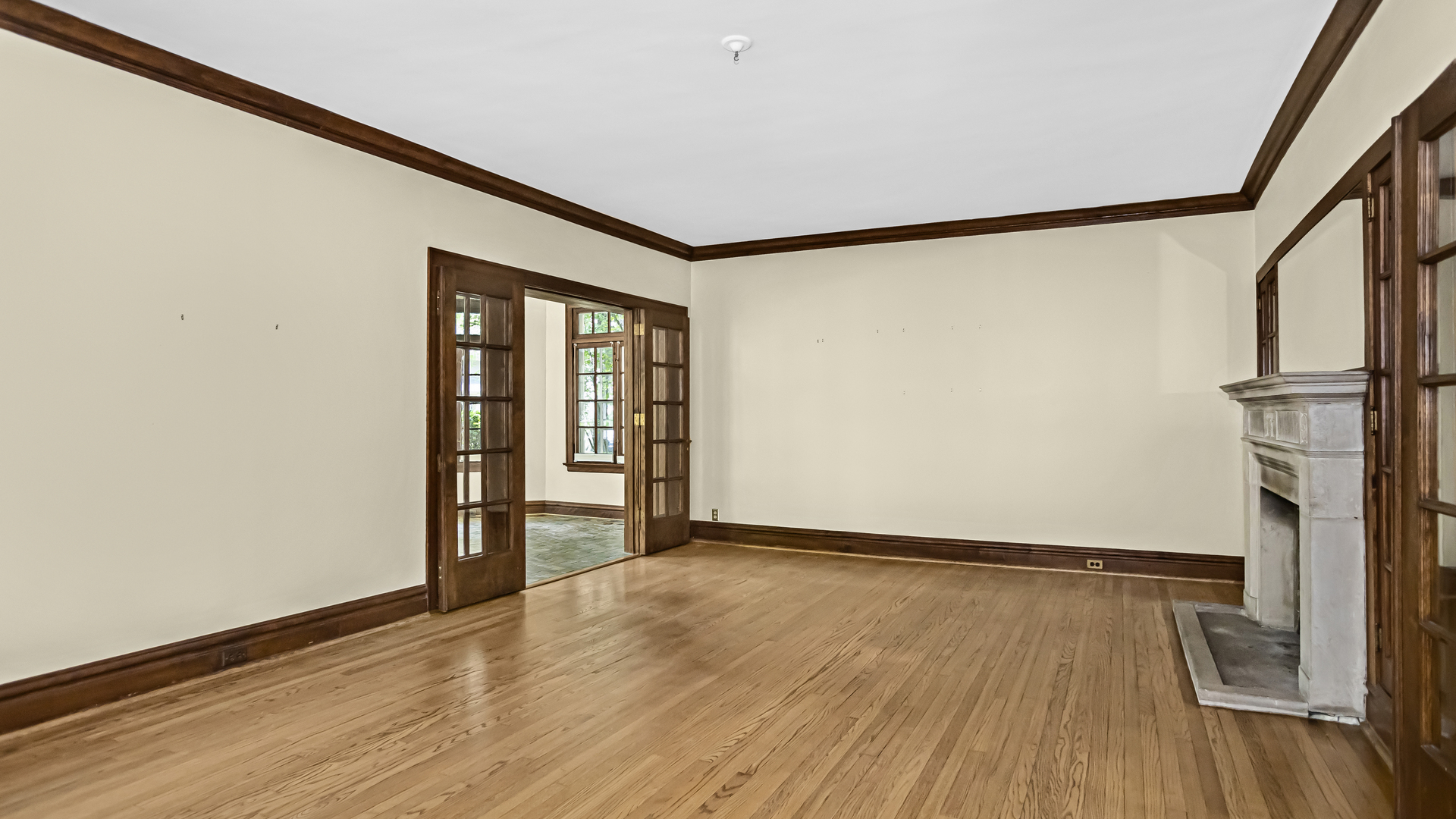 719 Milburn Street Evanston, IL 60201 - Photo 5 of 35 a view of an empty room with wooden floor and a window