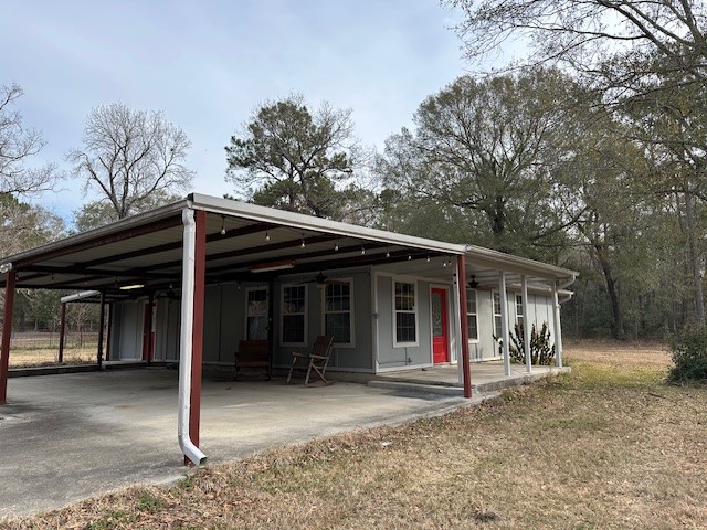 24331 Farm To Market Road 2090 Splendora, TX 77372 - Photo 19 of 38 a view of a barn with wooden wall and large tree