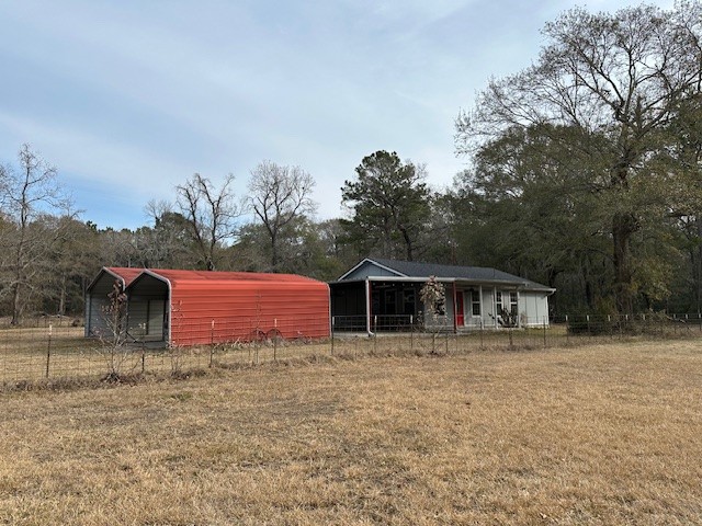 24331 Farm To Market Road 2090 Splendora, TX 77372 - Photo 21 of 38 a front view of a house with yard and trees