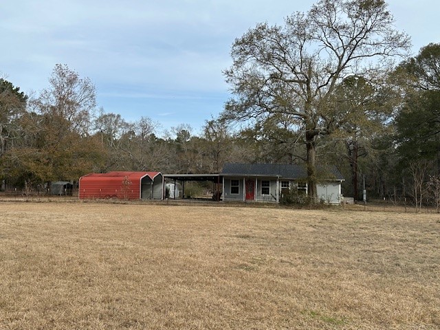 24331 Farm To Market Road 2090 Splendora, TX 77372 - Photo 22 of 38 front view of house with a yard