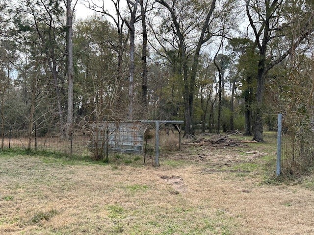 24331 Farm To Market Road 2090 Splendora, TX 77372 - Photo 24 of 38 a backyard of a house with lots of green space