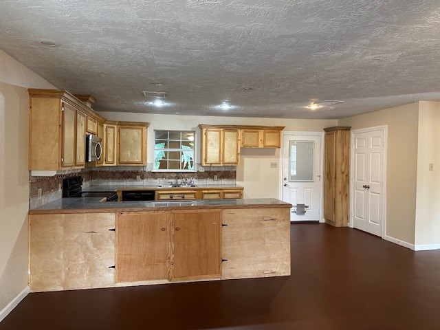 24331 Farm To Market Road 2090 Splendora, TX 77372 - Photo 3 of 38 a kitchen with stainless steel appliances granite countertop a stove and a refrigerator