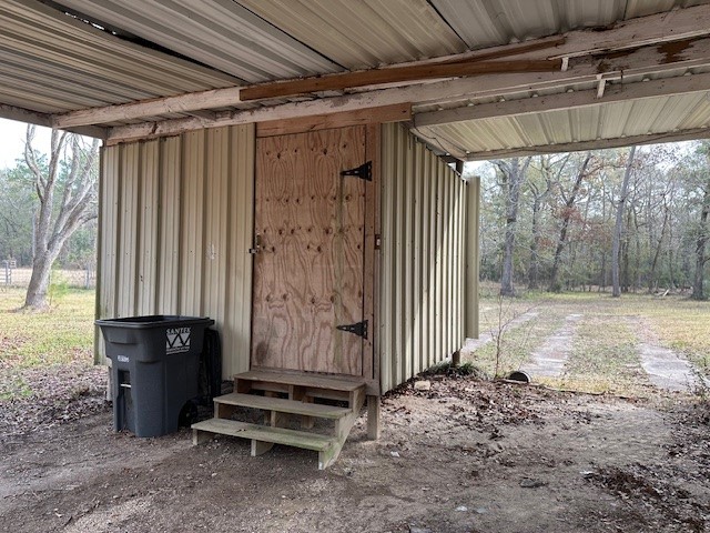 24331 Farm To Market Road 2090 Splendora, TX 77372 - Photo 37 of 38 a view of a room with wooden walls and stairs