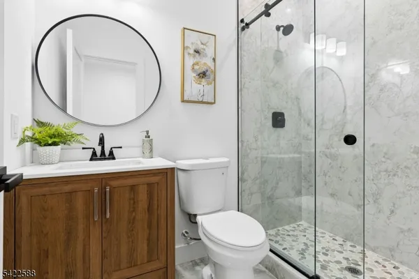 a bathroom with a sink a toilet and a mirror