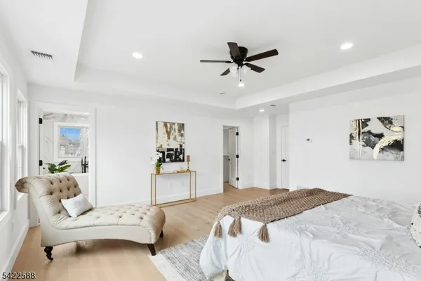 a bedroom with a white bed and white walls