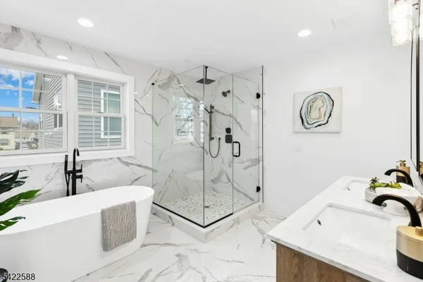 a bathroom with a bathtub sink and mirror