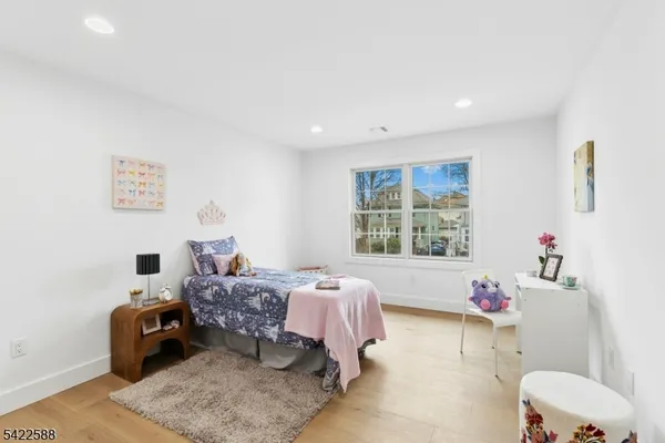 a bed room with a bed and a chair