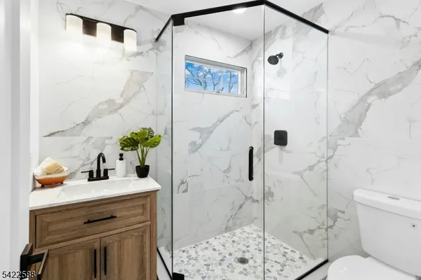 a bathroom with a sink toilet and shower