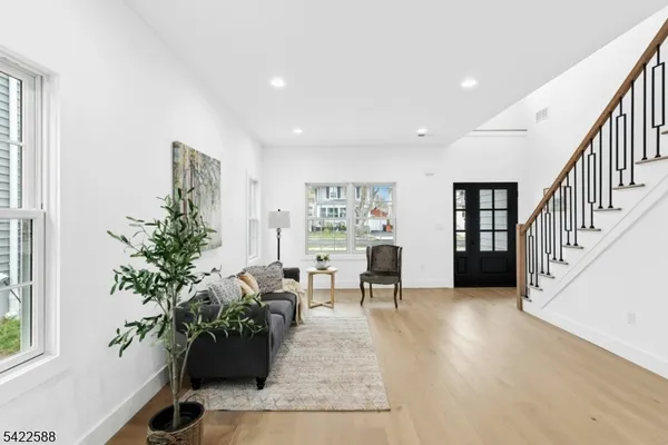 a living room with furniture potted plant and a window