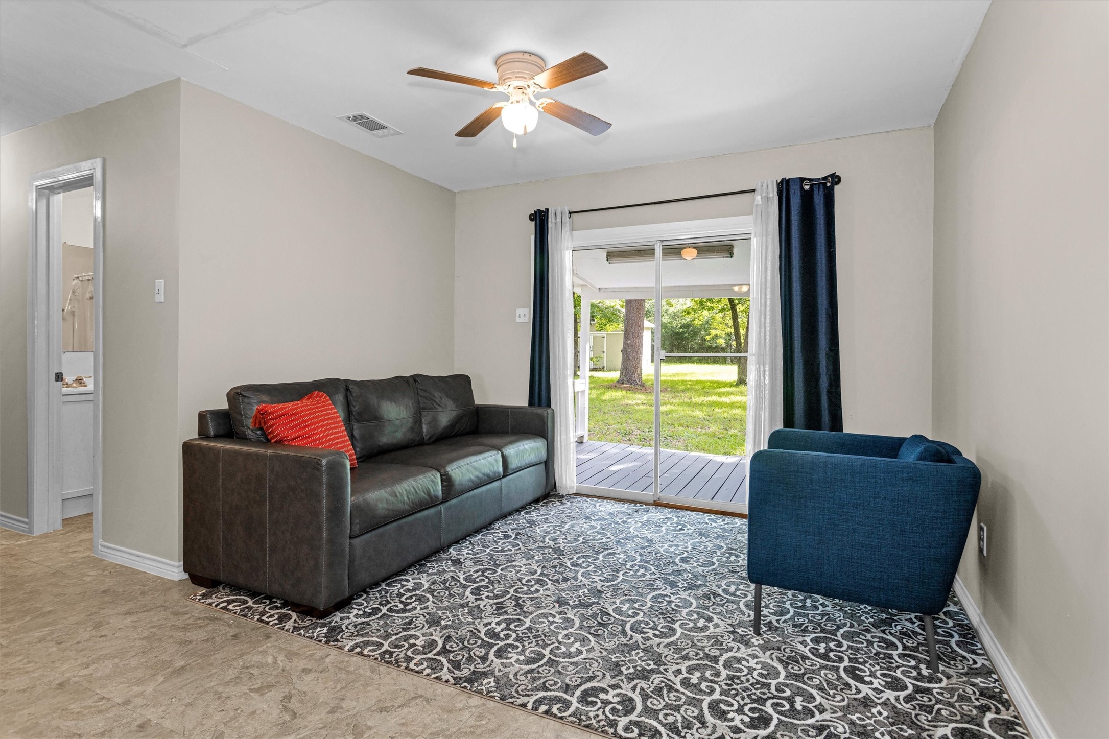 99 Main Street Huntsville, TX 77340 - Photo 18 of 47 The family room opens to a patio, offering an outdoor view.