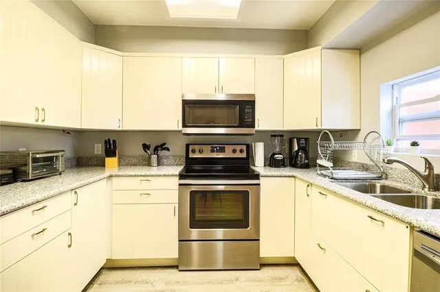 a spacious bedroom with a bed and wooden floor