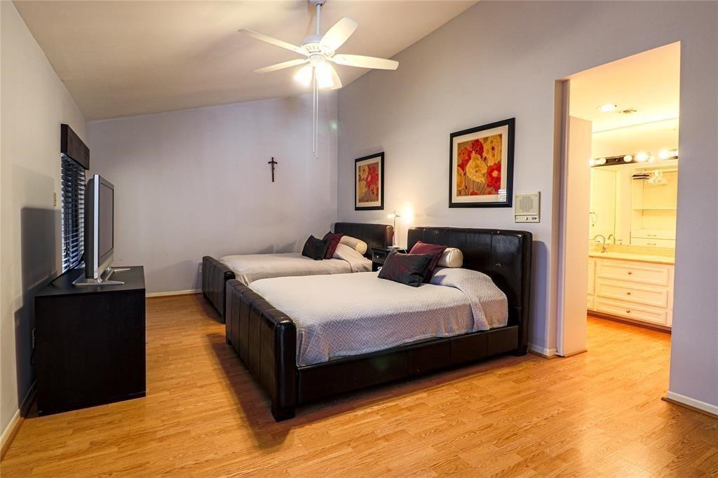 4724 Post Oak Timber Drive, Unit 8/65 Houston, TX 77056 - Photo 15 of 21 a spacious bedroom with a bed and wooden floor