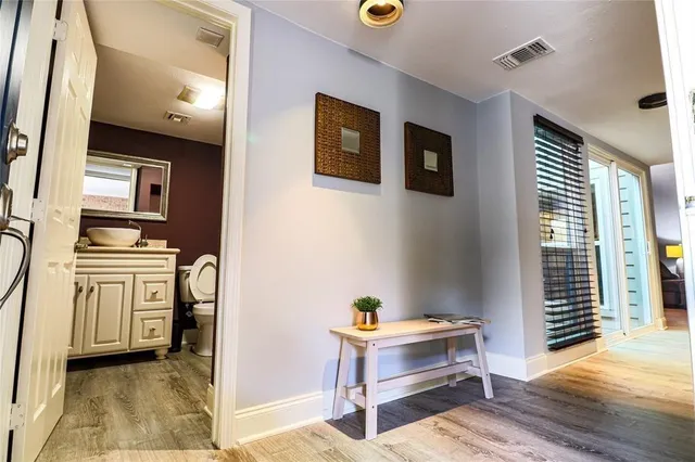 a bathroom with a toilet a sink and a mirror