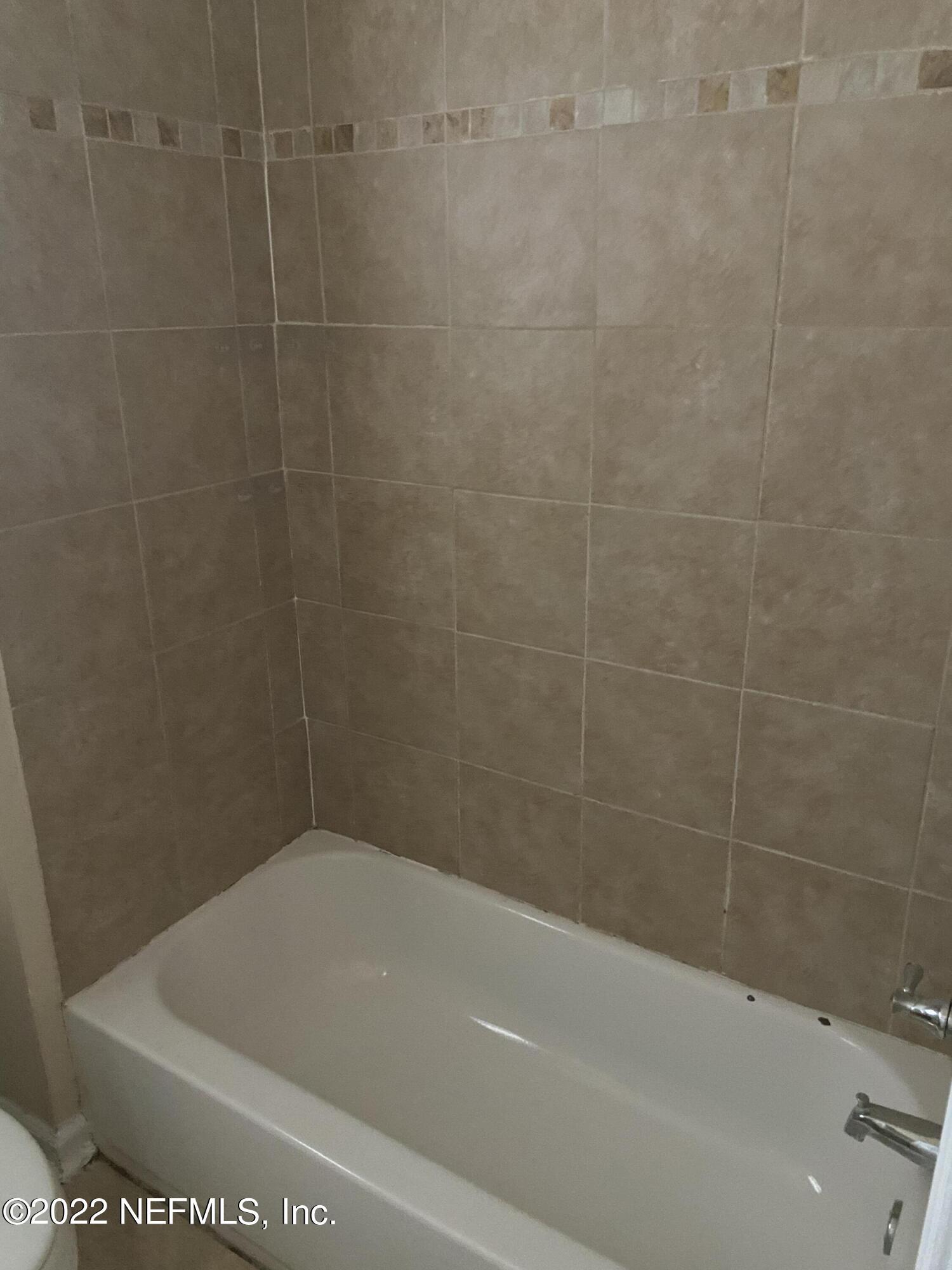 2158 Spring Park Road Jacksonville, FL 32207 - Photo 15 of 15 a bath tub sitting next to a white toilet
