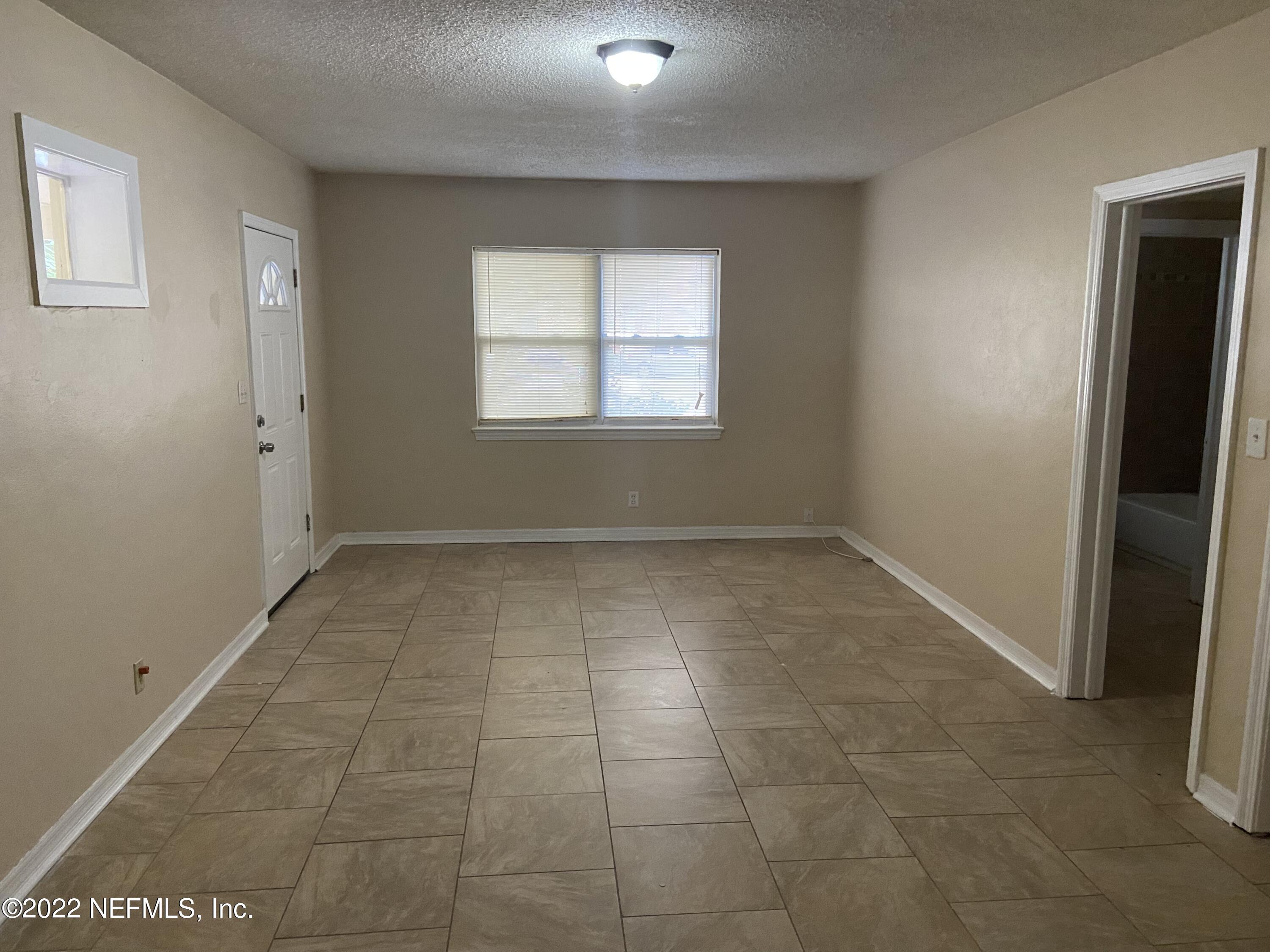 2158 Spring Park Road Jacksonville, FL 32207 - Photo 7 of 15 a view of an empty room with a window