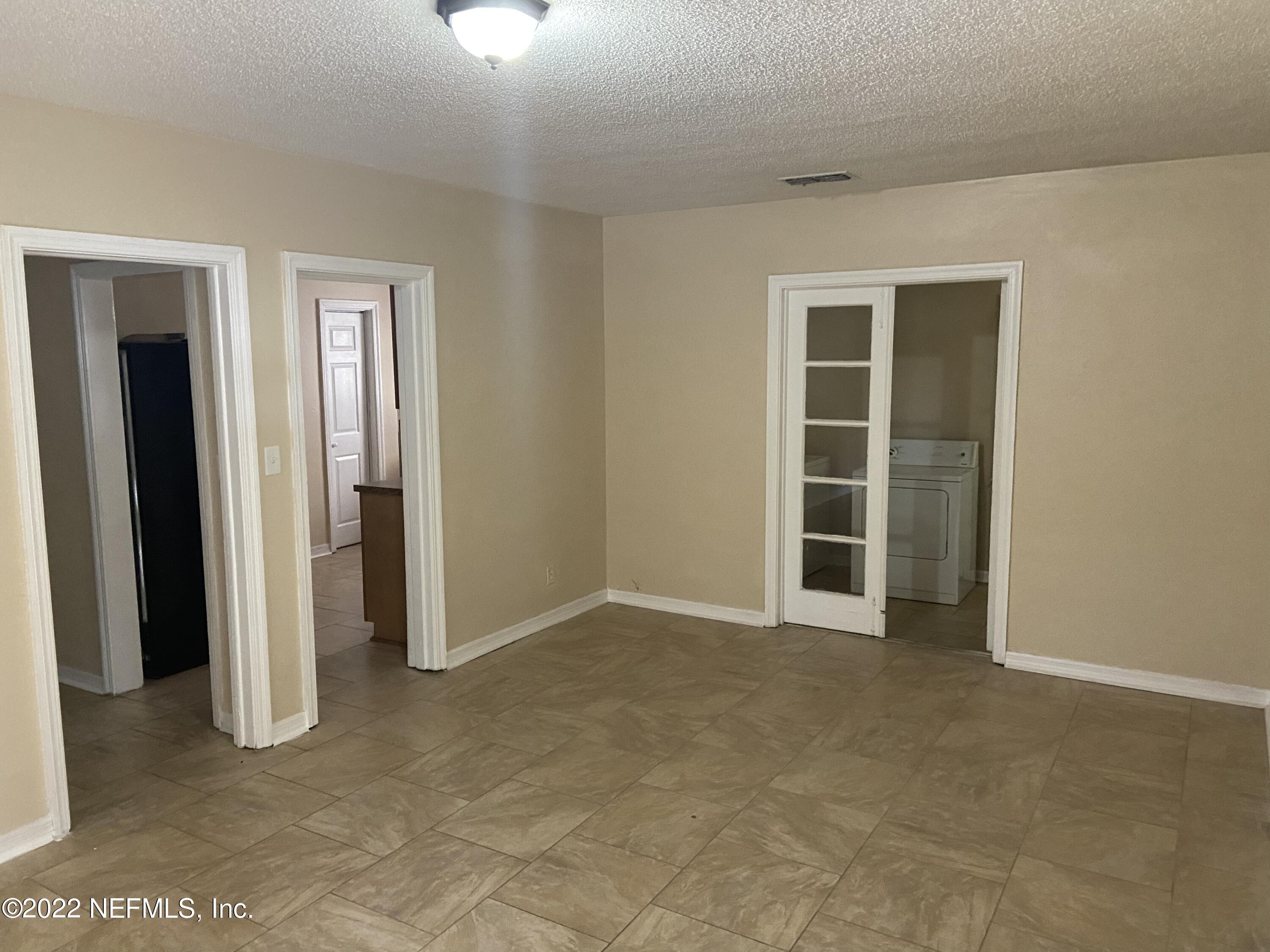 2158 Spring Park Road Jacksonville, FL 32207 - Photo 8 of 15 an empty room with closet and a window