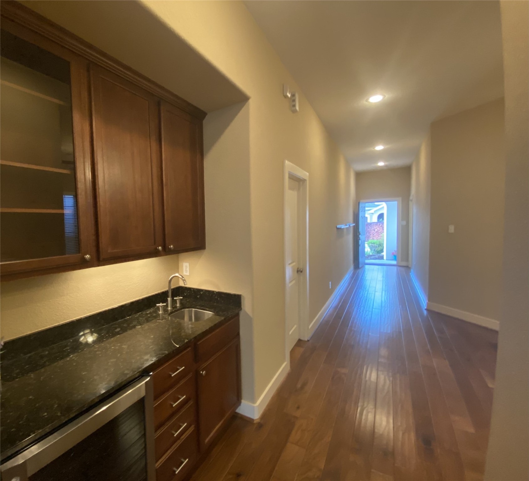 6057 Yale Street Houston, TX 77076 - Photo 11 of 49 a kitchen with wooden floor and a sink