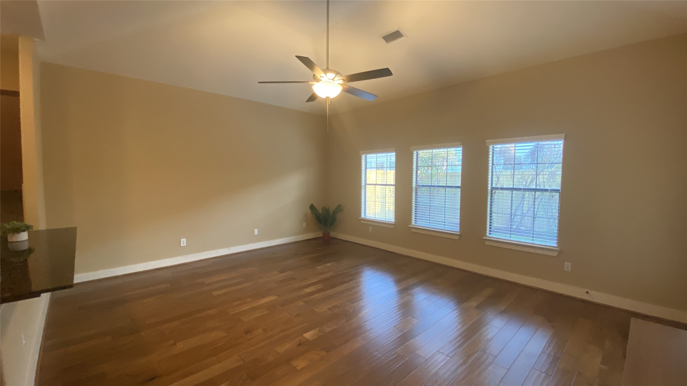 6057 Yale Street Houston, TX 77076 - Photo 12 of 49 a view of an empty room with wooden floor and a window