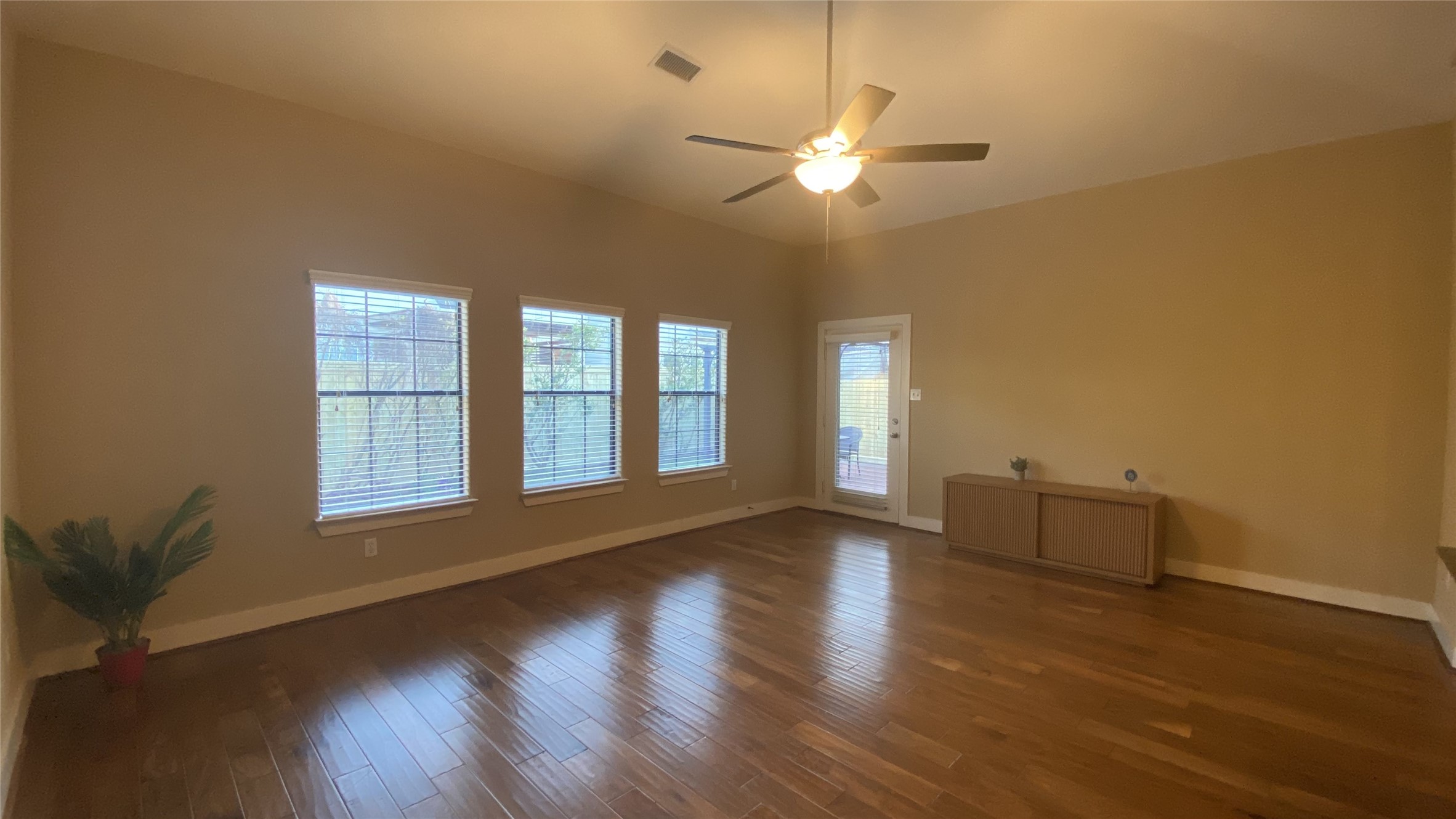 6057 Yale Street Houston, TX 77076 - Photo 13 of 49 a view of an empty room with wooden floor and a window