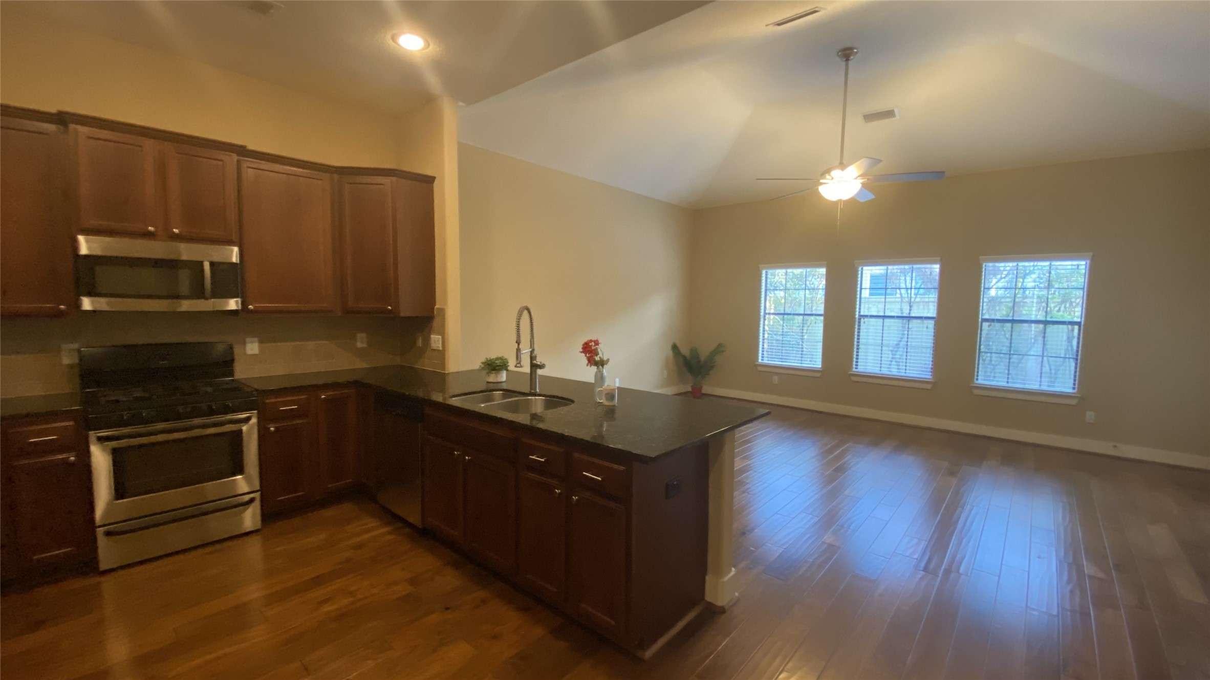 6057 Yale Street Houston, TX 77076 - Photo 16 of 49 a kitchen with stainless steel appliances granite countertop a stove a sink and a microwave