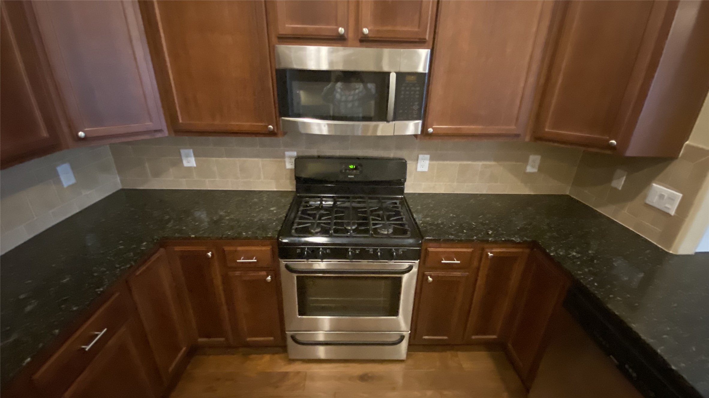 6057 Yale Street Houston, TX 77076 - Photo 19 of 49 a kitchen with a stove and a microwave