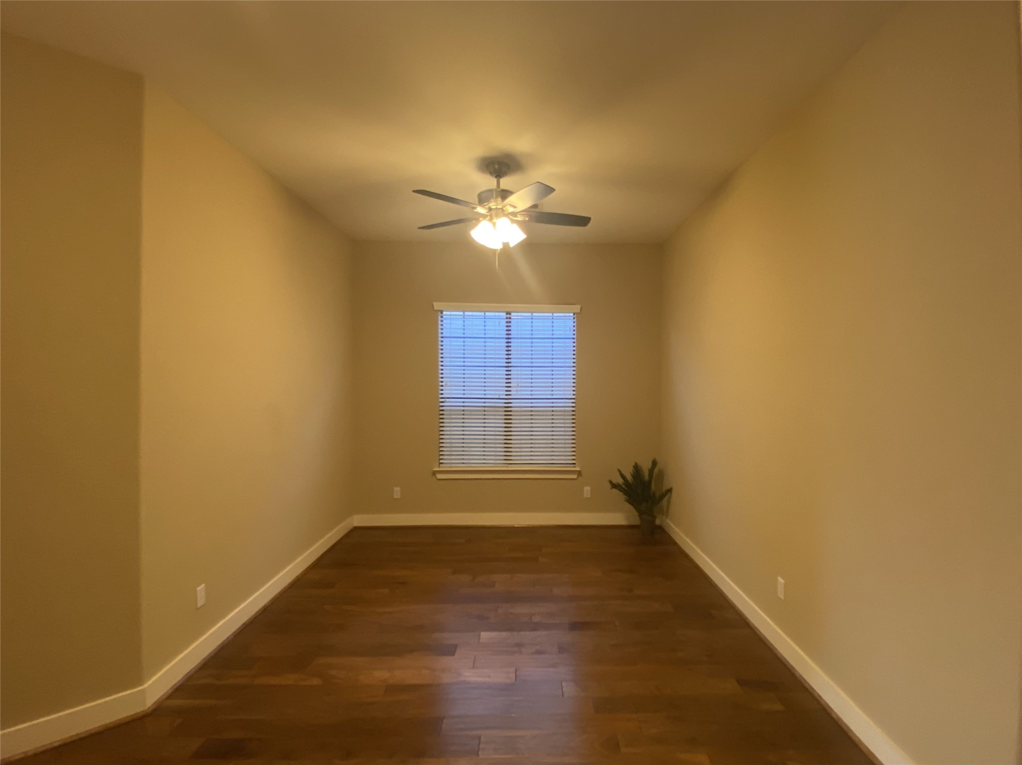6057 Yale Street Houston, TX 77076 - Photo 23 of 49 an empty room with a window and a ceiling fan
