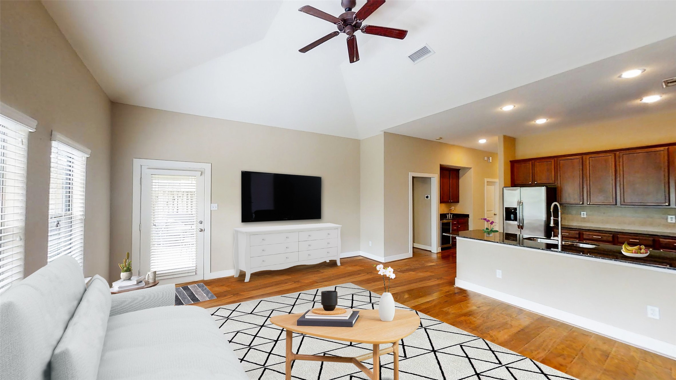 6057 Yale Street Houston, TX 77076 - Photo 27 of 49 a living room with stainless steel appliances a couch and a flat screen tv