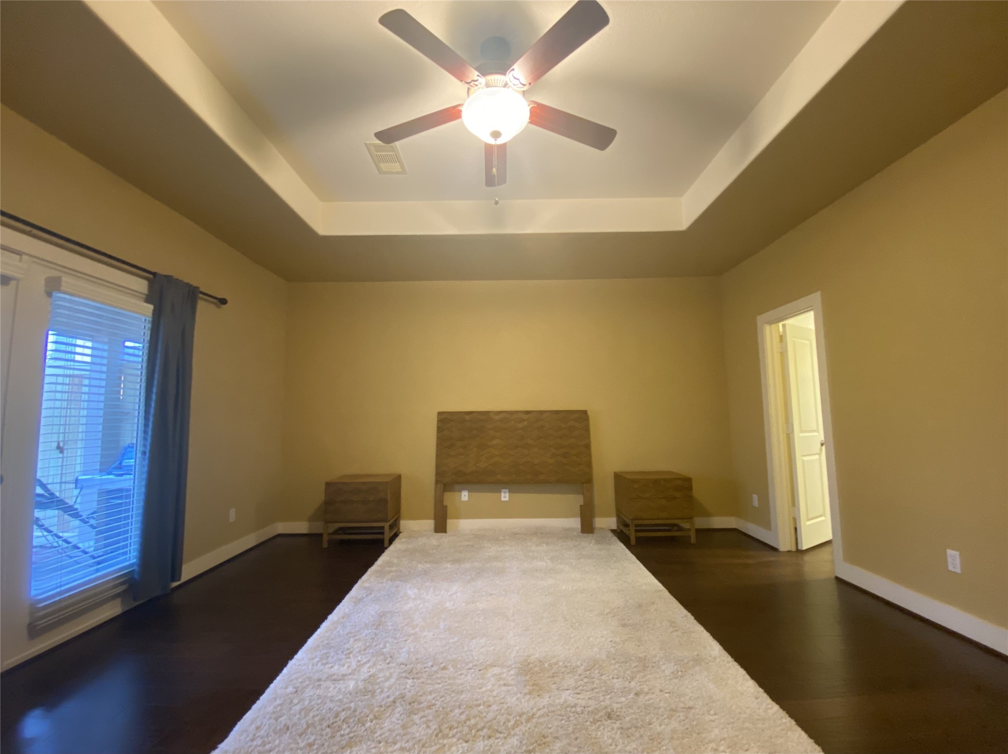 6057 Yale Street Houston, TX 77076 - Photo 32 of 49 a bedroom with a bed and a chandelier