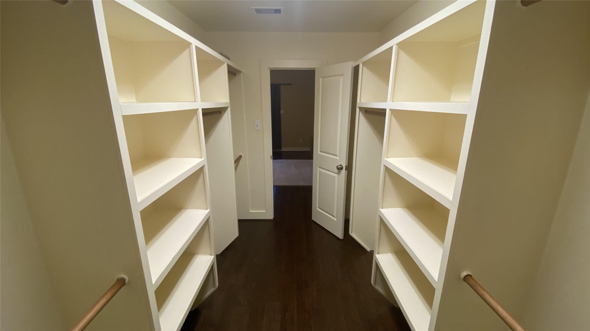6057 Yale Street Houston, TX 77076 - Photo 35 of 49 a view of walk in closet with wooden floor